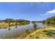 Picturesque lake view showcasing serene waters, lush greenery, and a tranquil environment at 5504 Beneva Woods Circle, Sarasota, FL 34233