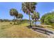 Scenic lake view featuring picnic tables, benches, and lush greenery at 5504 Beneva Woods Circle, Sarasota, FL 34233