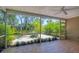 Screened-in lanai overlooking a beautifully landscaped backyard, perfect for outdoor relaxation at 5504 Beneva Woods Circle, Sarasota, FL 34233