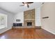 Spacious living room with brick fireplace, built-in shelving and sleek hardwood floors at 5504 Beneva Woods Circle, Sarasota, FL 34233