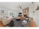 Stylish living room with a brick fireplace, white walls, and large windows at 5504 Beneva Woods Circle, Sarasota, FL 34233