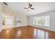 Bright living room with hardwood floors, large window, and views into the kitchen at 5504 Beneva Woods Circle, Sarasota, FL 34233
