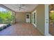 Relaxing screened patio with tile flooring, ceiling fan, and convenient access to the home's interior and lush surroundings at 5504 Beneva Woods Circle, Sarasota, FL 34233