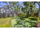 This backyard boasts a fun putting green surrounded by tropical plants and mature shade trees at 5504 Beneva Woods Circle, Sarasota, FL 34233