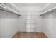 Walk-in closet featuring wire shelving and neutral carpeting for maximum storage at 5504 Beneva Woods Circle, Sarasota, FL 34233