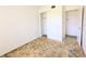 Bedroom featuring a built in closet and a door leading to an adjacent room at 5901 Garden Ln # H23, Bradenton, FL 34207