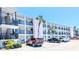 A clean three-story condo building with black wrought iron railings and covered parking on a bright, sunny day at 5901 Garden Ln # H23, Bradenton, FL 34207