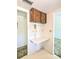 A kitchen's built-in wall desk with mushroom-themed tiling and upper wood cabinets provides a work-from-home space at 5901 Garden Ln # H23, Bradenton, FL 34207