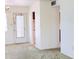 Open living room featuring an exterior door and view to kitchen area at 5901 Garden Ln # H23, Bradenton, FL 34207