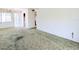 View of a carpeted living room with connections to the outside and kitchen spaces at 5901 Garden Ln # H23, Bradenton, FL 34207