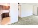 A living room flows into the kitchen area, with a sliding glass door providing plenty of natural light at 5901 Garden Ln # H23, Bradenton, FL 34207