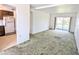 A living room flows into the kitchen area, with a sliding glass door providing plenty of natural light at 5901 Garden Ln # H23, Bradenton, FL 34207