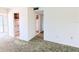 View of a carpeted living room with connections to the outside and kitchen spaces at 5901 Garden Ln # H23, Bradenton, FL 34207