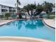 Community pool with crystal clear water and surrounding lounge area offering residents a place to relax at 5901 Garden Ln # H23, Bradenton, FL 34207