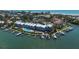 Waterfront Community: aerial shot of the complex, community pool, docks, and boat slips on the water at 615 Dream Island Pl # 303, Longboat Key, FL 34228