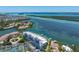 Waterfront complex: an aerial view highlighting the coastal community near the water and neighboring islands at 615 Dream Island Pl # 303, Longboat Key, FL 34228