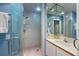 Bathroom with a glass enclosed shower, decorative mirror, and vanity at 615 Dream Island Pl # 303, Longboat Key, FL 34228