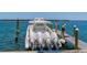 Boat docked at the pier with multiple engines in a marina setting at 615 Dream Island Pl # 303, Longboat Key, FL 34228