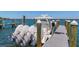 Boat docked at the pier with multiple engines, against clear blue sky at 615 Dream Island Pl # 303, Longboat Key, FL 34228