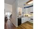 The kitchen features white cabinets, wood floor and transitions to the living space at 615 Dream Island Pl # 303, Longboat Key, FL 34228