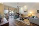 Open floor plan living room features a ceiling fan and sliding glass doors to a balcony at 615 Dream Island Pl # 303, Longboat Key, FL 34228