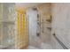 Walk-in shower features stylish glass block wall, shower head and handrail at 615 Dream Island Pl # 303, Longboat Key, FL 34228