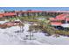 Aerial view showing a condo complex near a sandy beach with lush landscaping and relaxing community spaces at 6236 Midnight Pass Rd # 300, Sarasota, FL 34242