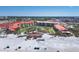 Expansive aerial shot showcases a beachside condominium complex, offering stunning views and luxurious living at 6236 Midnight Pass Rd # 300, Sarasota, FL 34242