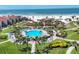 Scenic aerial view of a condo near the beach featuring palm trees, a pool and community space to relax at 6236 Midnight Pass Rd # 300, Sarasota, FL 34242