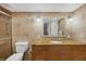 Bathroom featuring a stone-tiled wall, shower, toilet and vanity with a granite countertop at 6236 Midnight Pass Rd # 300, Sarasota, FL 34242