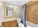 Bathroom features stone-tile, a shower-tub, vanity with granite countertop, and a framed mirror at 6236 Midnight Pass Rd # 300, Sarasota, FL 34242