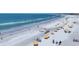 A beautiful beach with white sand, clear water, and yellow umbrellas and chairs for relaxing in the sun at 6236 Midnight Pass Rd # 300, Sarasota, FL 34242
