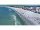 Enjoy breathtaking ocean views with white sand, clear turquoise waters, and distant buildings at 6236 Midnight Pass Rd # 300, Sarasota, FL 34242
