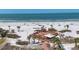 Picturesque aerial view of beach front clubhouse overlooking calm waters, sandy beach, and clear blue sky at 6236 Midnight Pass Rd # 300, Sarasota, FL 34242