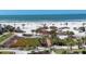 Stunning aerial view showcases a wide sandy beach, blue ocean, and a charming gazebo at 6236 Midnight Pass Rd # 300, Sarasota, FL 34242