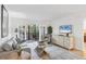 Inviting living room with neutral tones, balcony access, and natural light at 6236 Midnight Pass Rd # 300, Sarasota, FL 34242