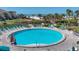 Pool area with lounge chairs, palm trees, and beach views in the background at 6236 Midnight Pass Rd # 300, Sarasota, FL 34242