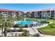 A lovely condominium complex featuring a pristine outdoor pool area surrounded by lush landscaping and comfortable seating at 6236 Midnight Pass Rd # 300, Sarasota, FL 34242