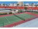 Overhead shot of a red and green tennis court, ready for a game on a sunny day at 6236 Midnight Pass Rd # 300, Sarasota, FL 34242