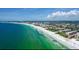 Stunning aerial view showcases the pristine white sand beach and turquoise waters along the coastline at 6480 Midnight Pass Rd # 316, Sarasota, FL 34242
