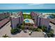 Coastal condo complex featuring a pool, lush landscaping and direct beach access at 6480 Midnight Pass Rd # 316, Sarasota, FL 34242