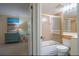 Bathroom with a shower/tub combo, a blue dresser in the connected bedroom at 6480 Midnight Pass Rd # 316, Sarasota, FL 34242