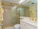 Bathroom featuring a shower with gold trim, double sinks and great lighting at 6480 Midnight Pass Rd # 316, Sarasota, FL 34242
