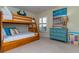 Bedroom with a bunk bed, a sunny window and a dresser with colorful decorations at 6480 Midnight Pass Rd # 316, Sarasota, FL 34242