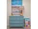 Bedroom with a turquoise dresser, lamp, and a colorful basket at 6480 Midnight Pass Rd # 316, Sarasota, FL 34242