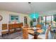 Open concept dining room with beach views and wicker chairs at 6480 Midnight Pass Rd # 316, Sarasota, FL 34242