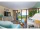 Comfortable living room with ocean view balcony access and beautiful coastal-themed decorations at 6480 Midnight Pass Rd # 316, Sarasota, FL 34242