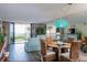 Bright living room and dining area with ocean view balcony access and stylish coastal decor at 6480 Midnight Pass Rd # 316, Sarasota, FL 34242
