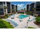 Condo complex featuring a pool and lounge area at 6480 Midnight Pass Rd # 316, Sarasota, FL 34242