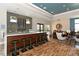 Stylish bar area with modern stools, a long countertop, and comfortable lounge seating nearby at 7044 Whittlebury Trl, Bradenton, FL 34202